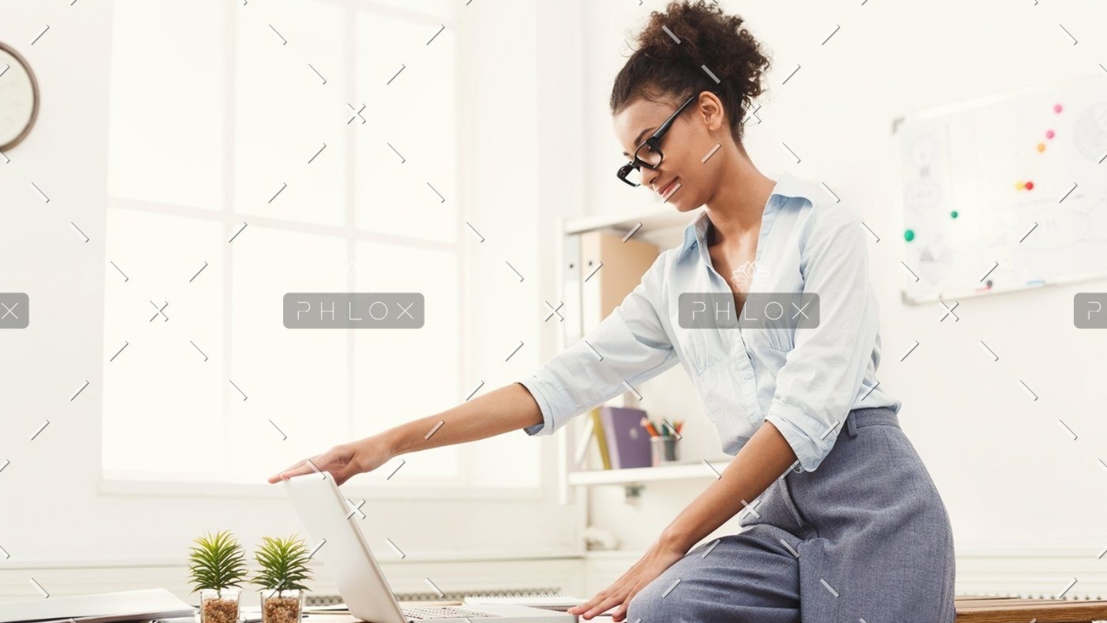 demo-attachment-184-business-woman-opening-laptop-at-office-PU4ZAGW